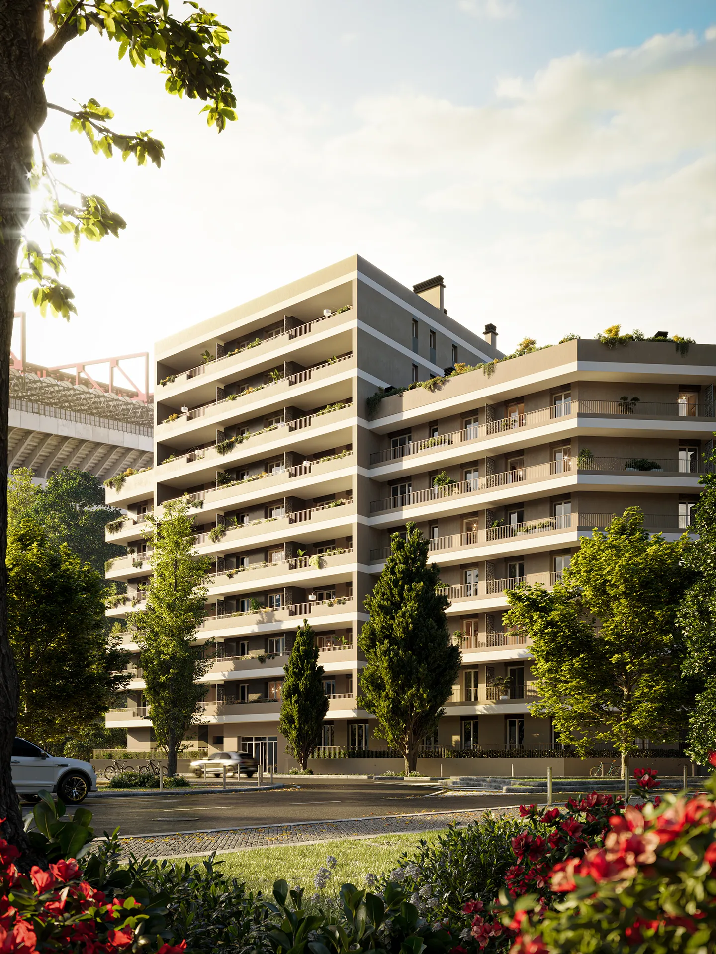 Edificio residenziale moderno circondato da alberi e fiori al tramonto.